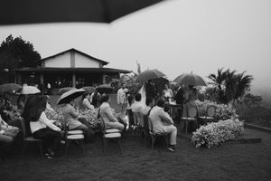 A black and white historical photograph shows temporary shelters and tents set up in a refugee camp.