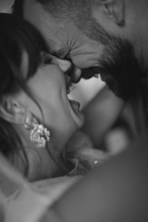Intimate black and white close-up photograph of romantic moment.