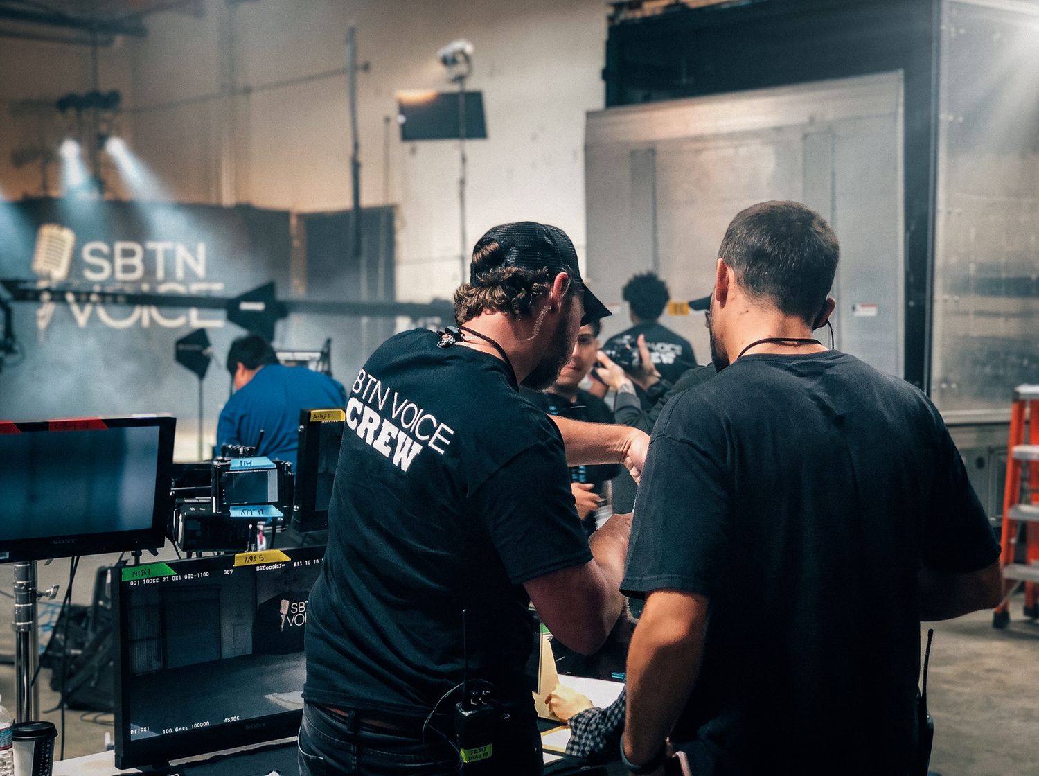 Reptile Rescue production still: a man tending terrariums in a reptile facility.
