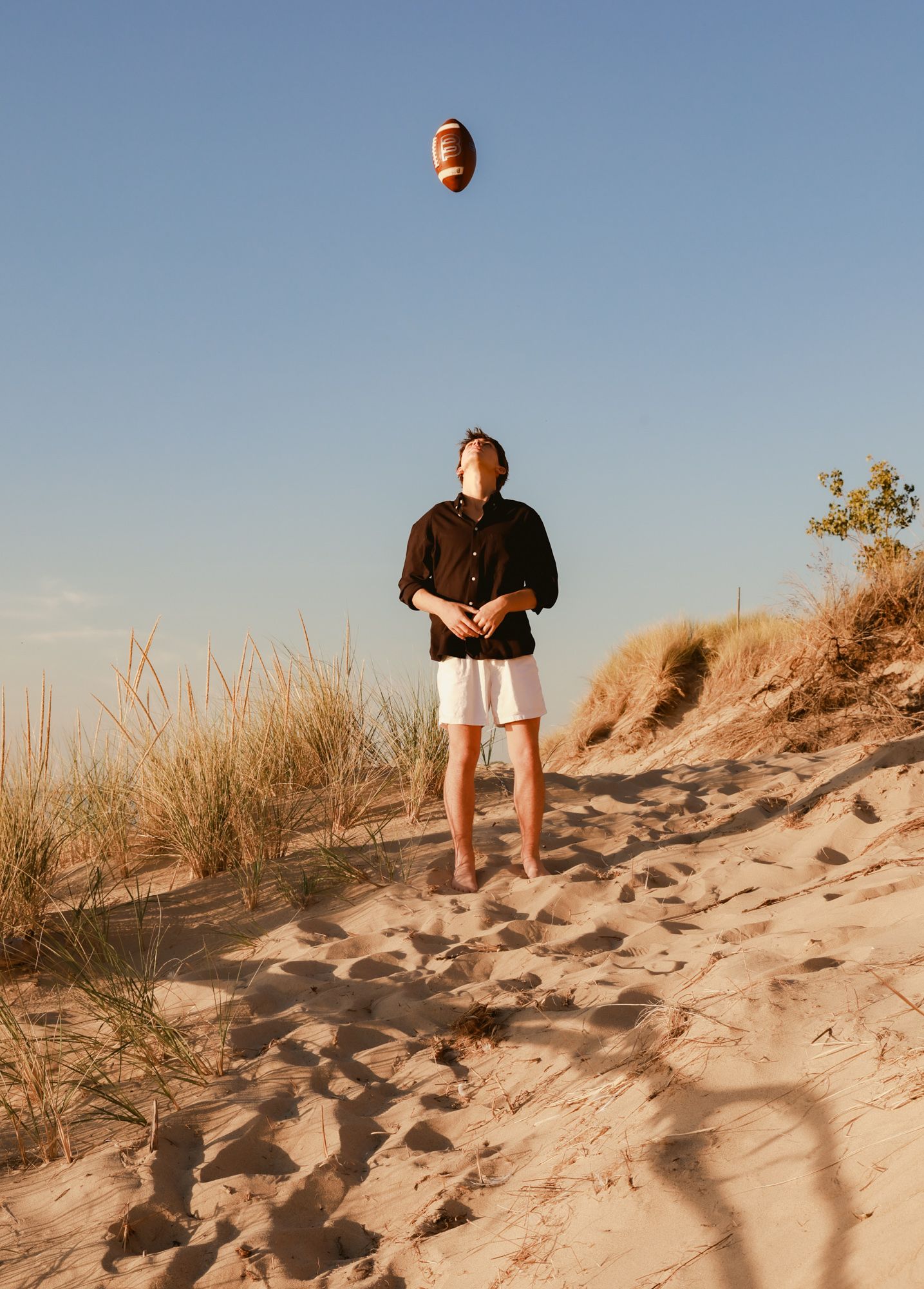 A sequence of photos showing someone walking up a sandy dune at sunset with long shadows cast across the sand.