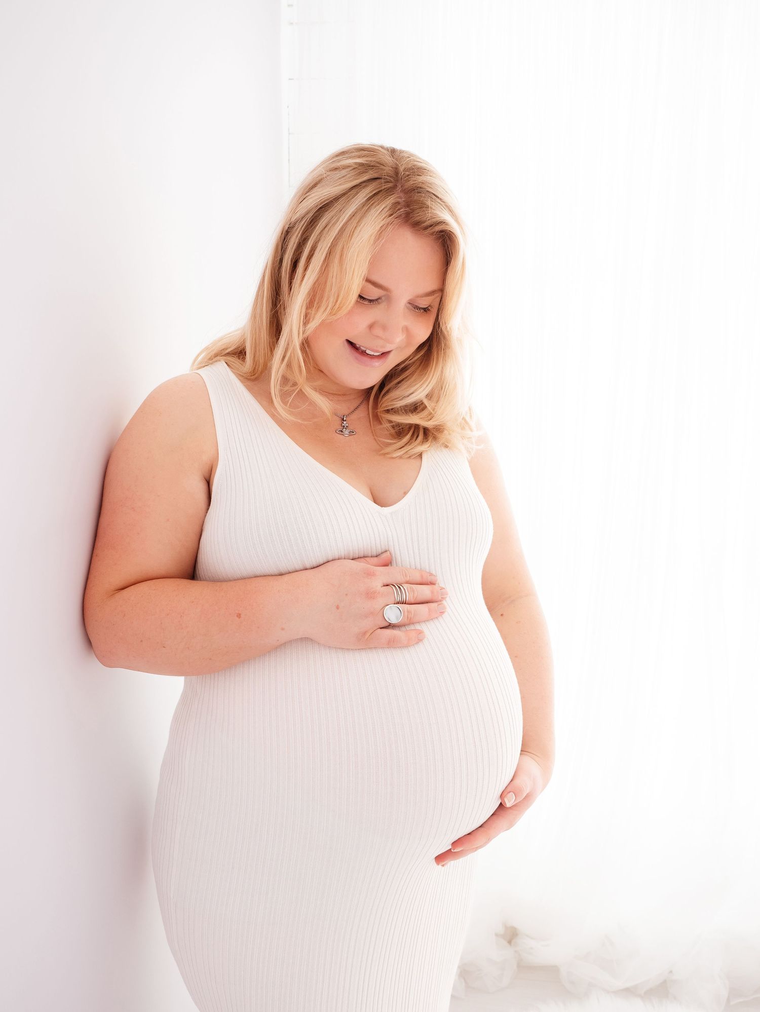 self portrait of Didcot based maternity and newborn photographer Verity, wearing a white top.