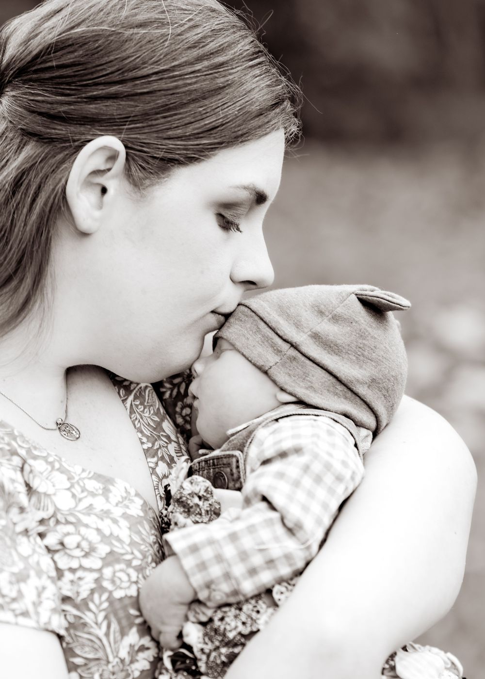A series of black and white photos showing a tender moment between two people in a romantic embrace.