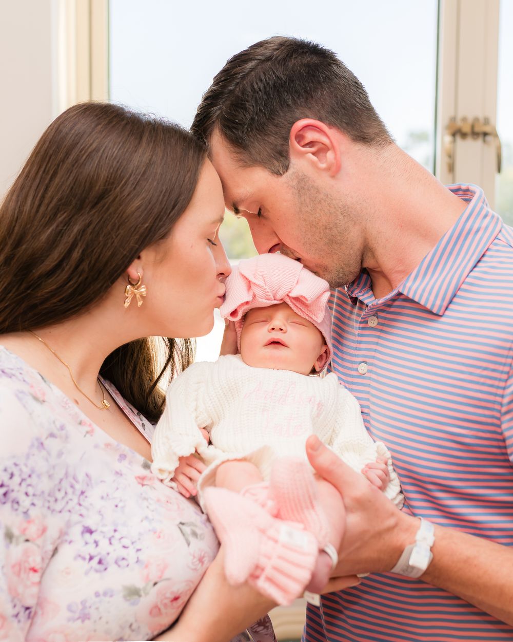 A couple shares tender moments with their newborn baby in a series of intimate family portraits.