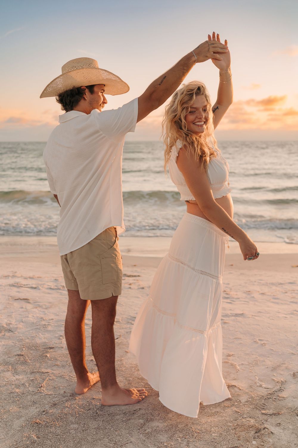 Couple embracing with sunset behind them