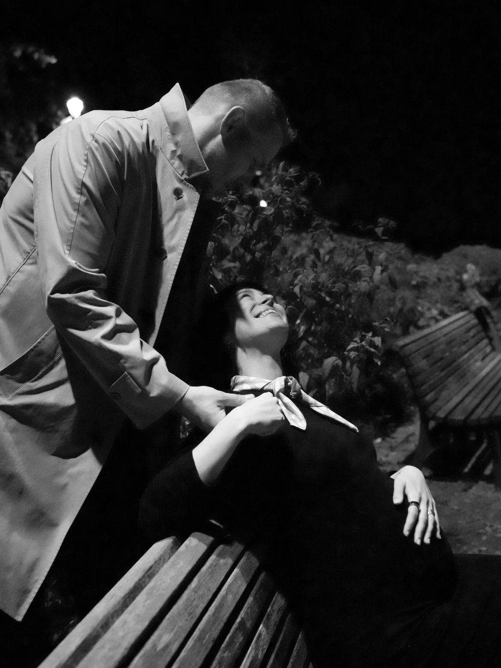 A man hugs a pregnant wife.