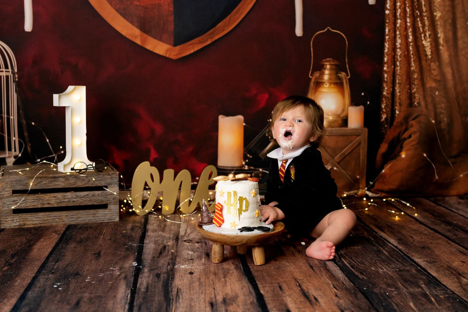 Toddler enjoying a 1st birthday cake smash session in a Bothell studio. Fun, authentic birthday photography by Filling the Frame Photography