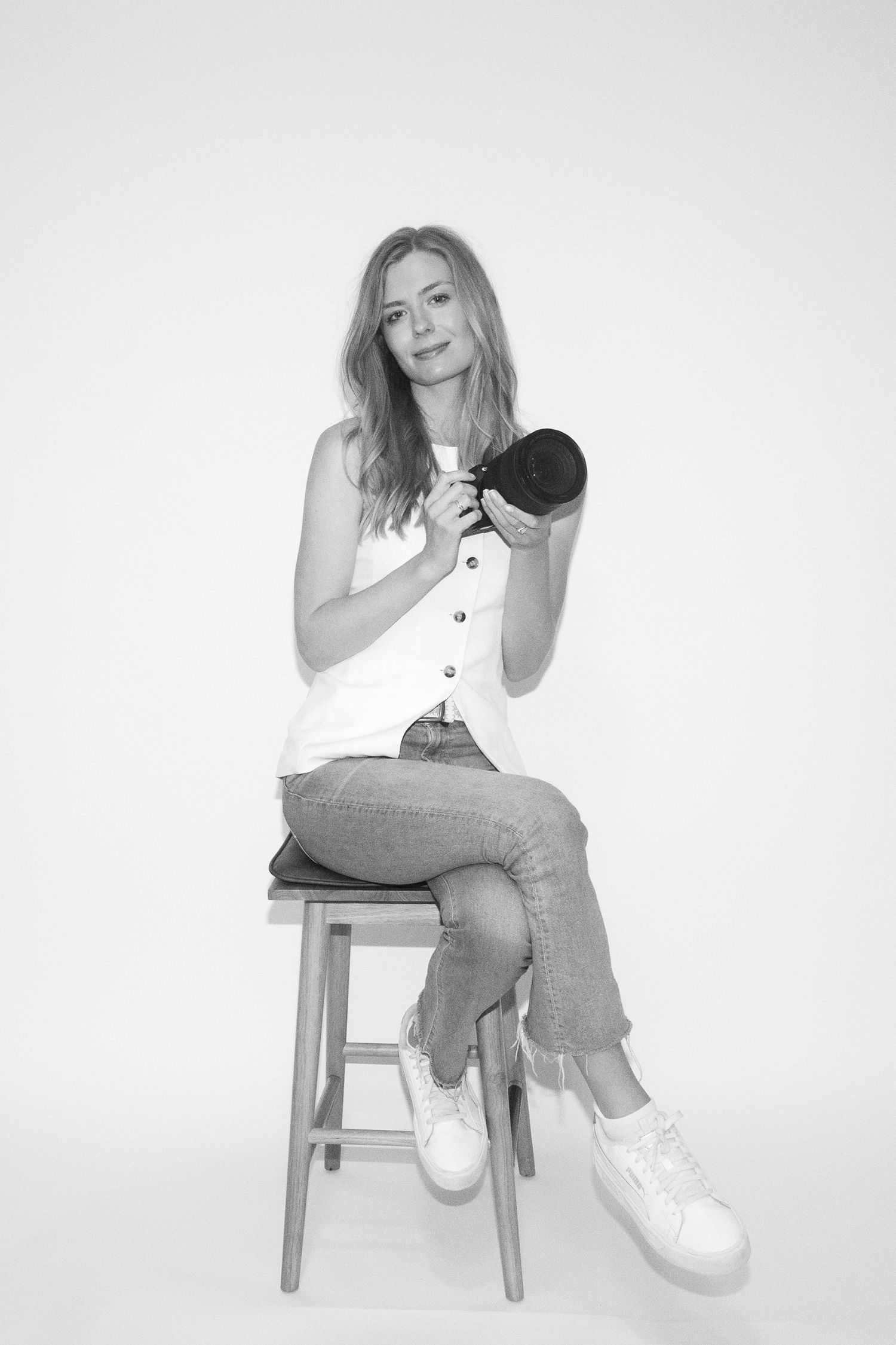 Black and white studio portrait of Everett Digital holding a camera in Fort Worth Texas. A Fort Worth based photographer.