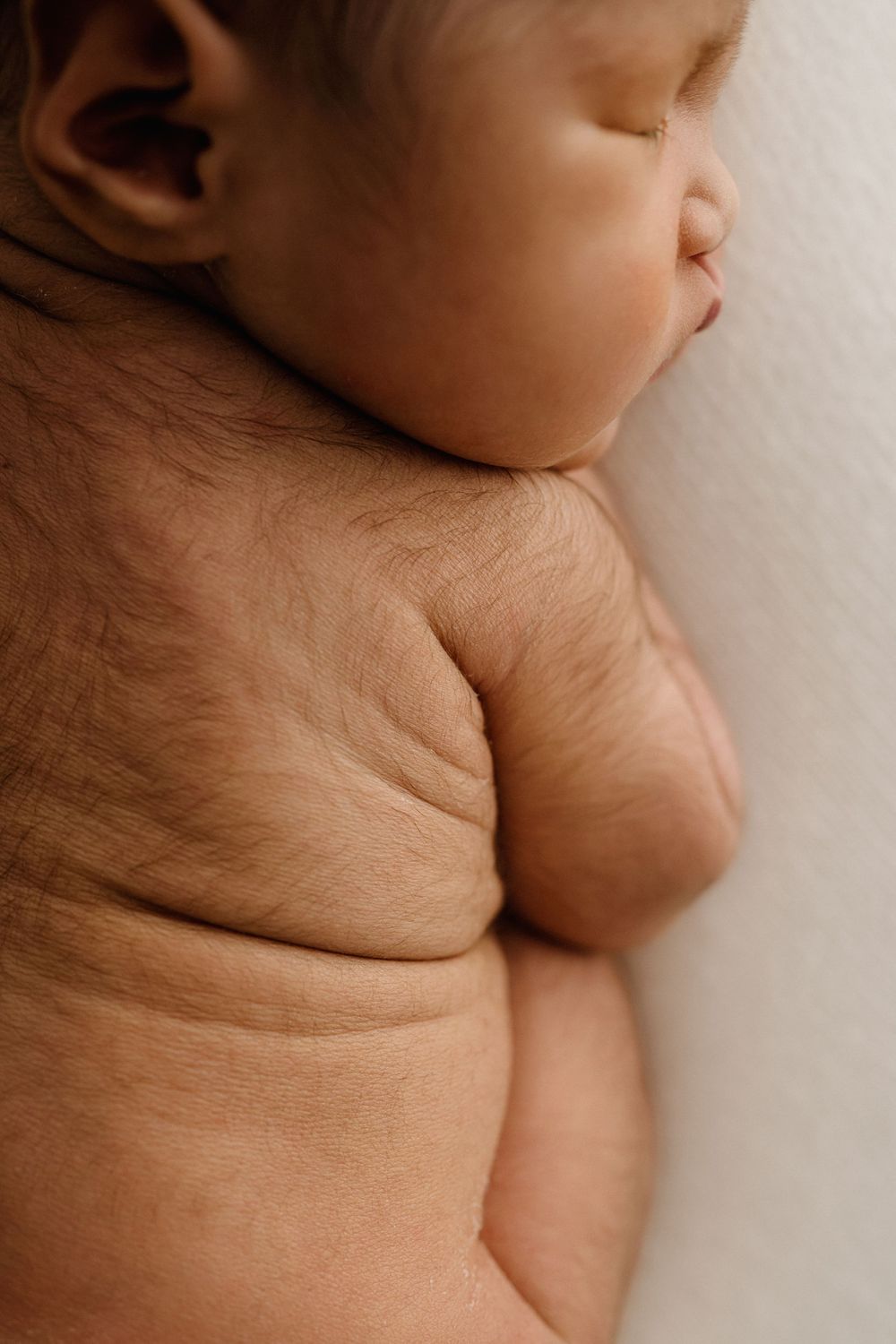 Close-up series of skin folds and creases showing the texture and natural contours of a baby's neck and shoulder.