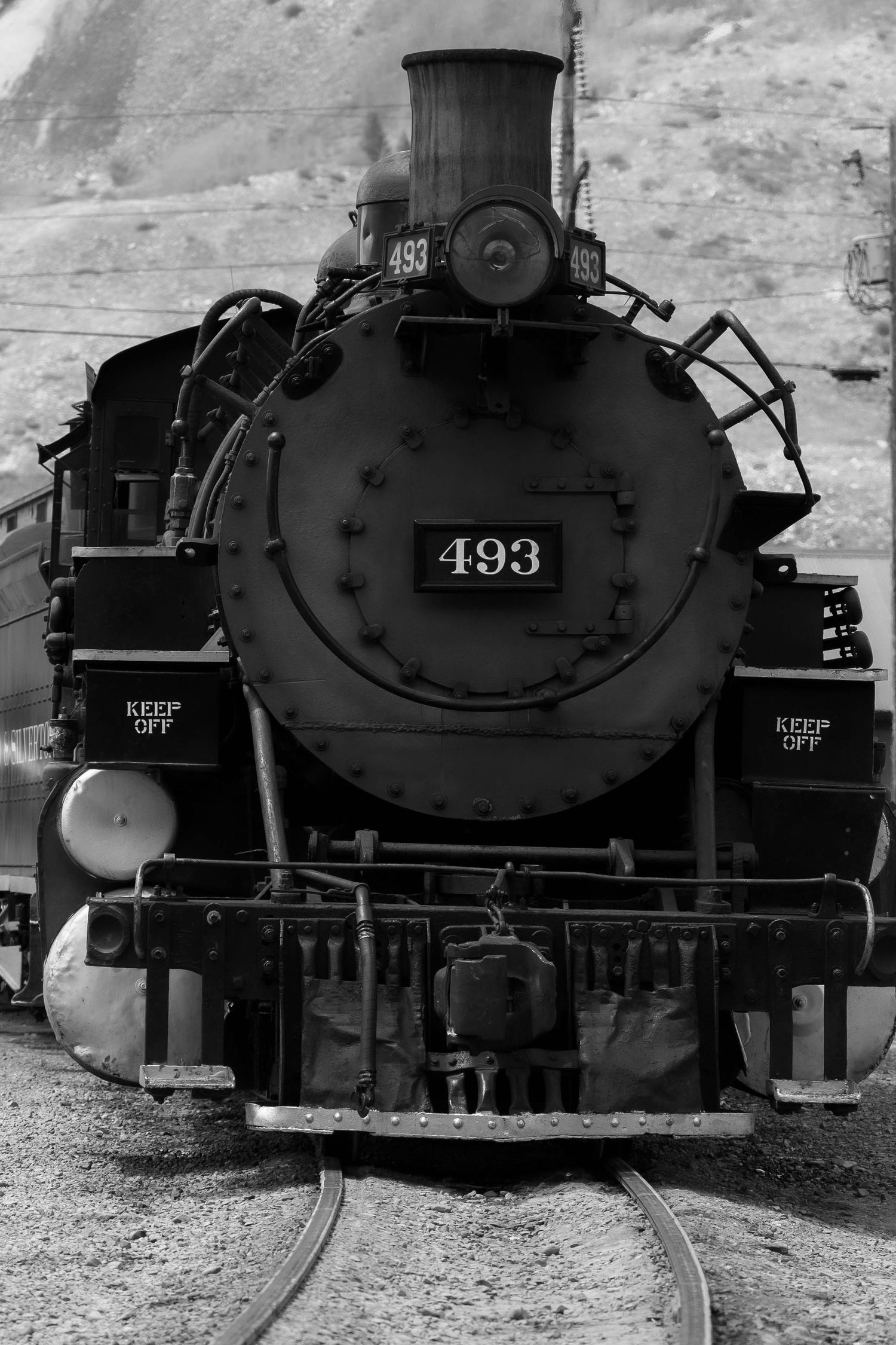 Vintage steam locomotive number 493 displayed in black and white with detailed front view.