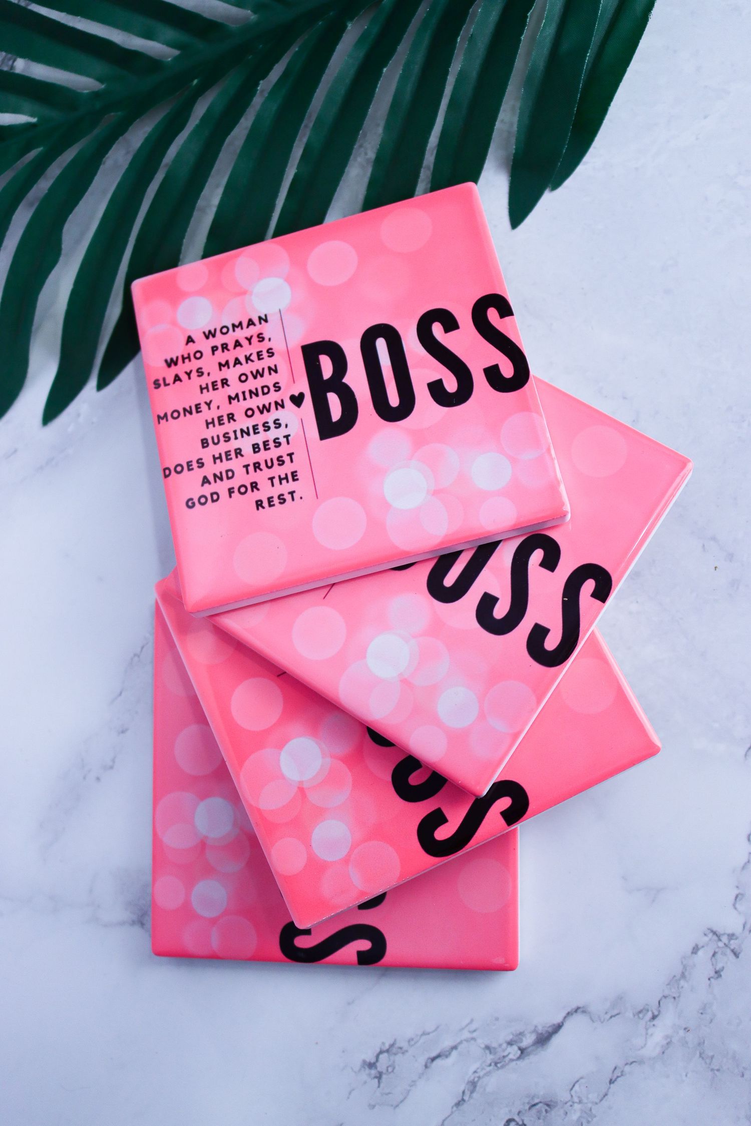Pink business cards with polka dot pattern and black text displayed on marble background.