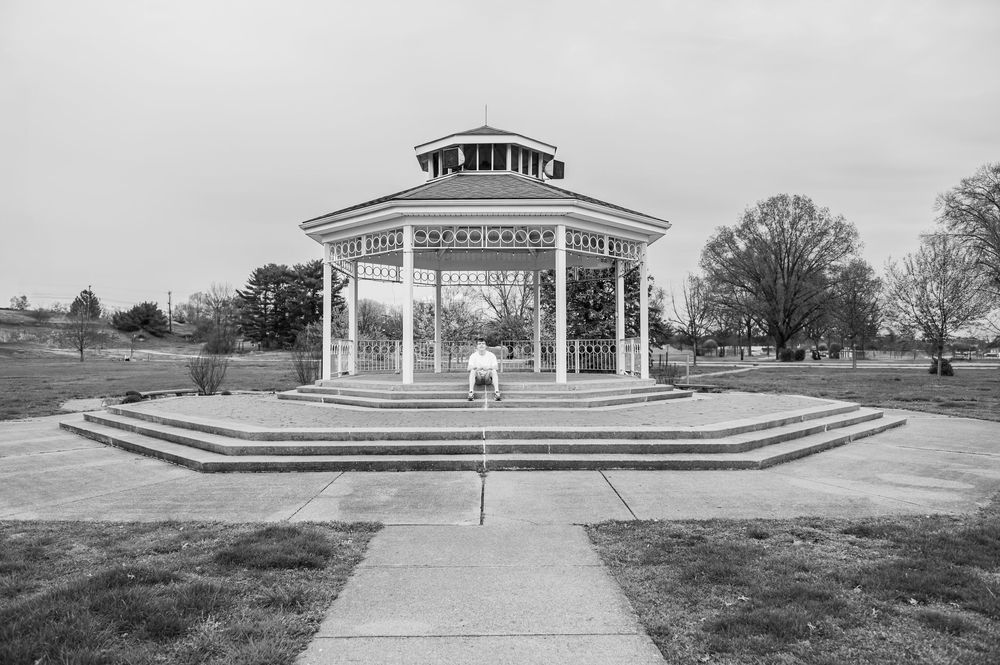 A panoramic view of an outdoor amphitheater with white pillars and steps.