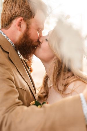 Intimate wedding portrait capturing tender moment between newlyweds.