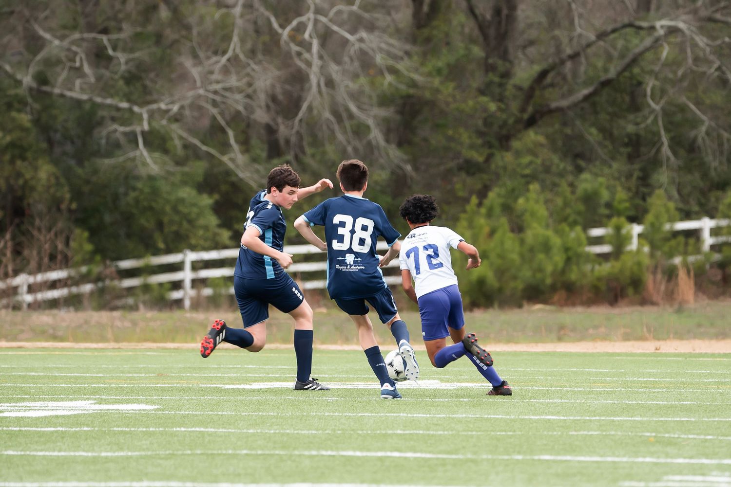 Players diving and sliding on the field during an intense soccer match sequence.