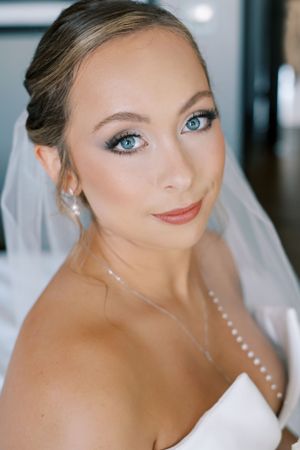 Bridal portrait showing delicate veil and elegant makeup.