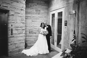 A sequence of black and white wedding photos showing a bride in a flowing white dress entering a stone building.