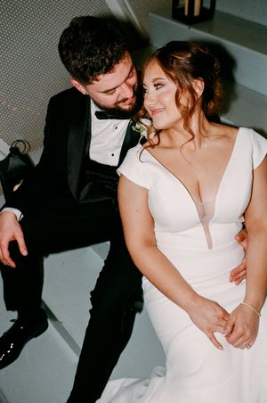 A couple in formal wedding attire share an intimate moment in a series of candid black and white photographs.