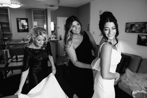 Candid black and white photos show a bride getting ready in various stages on her wedding day.