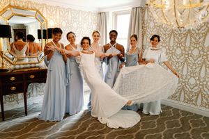 A sequence of wedding party photos in elegant grey and white attire against ornate gold wallpaper in a luxurious venue.