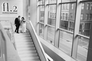 A series of security camera views showing an empty stairwell and hallway in a modern commercial building.
