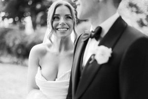 A black and white collage of wedding photos showing happy couples and wedding party members at a formal celebration.