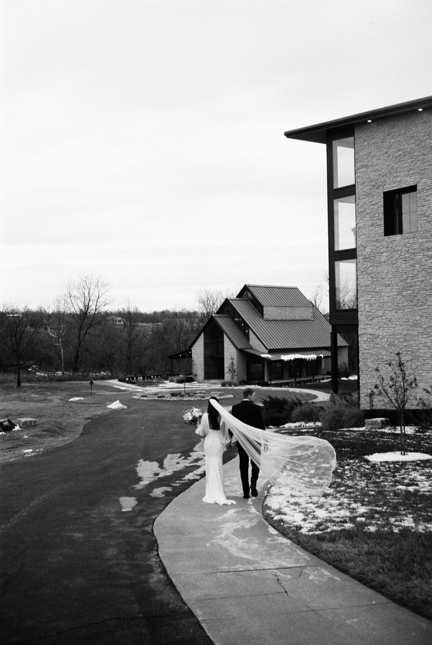 A couple walking outside Osage House in Arkansas, photographed by Alyson Kay Photography.