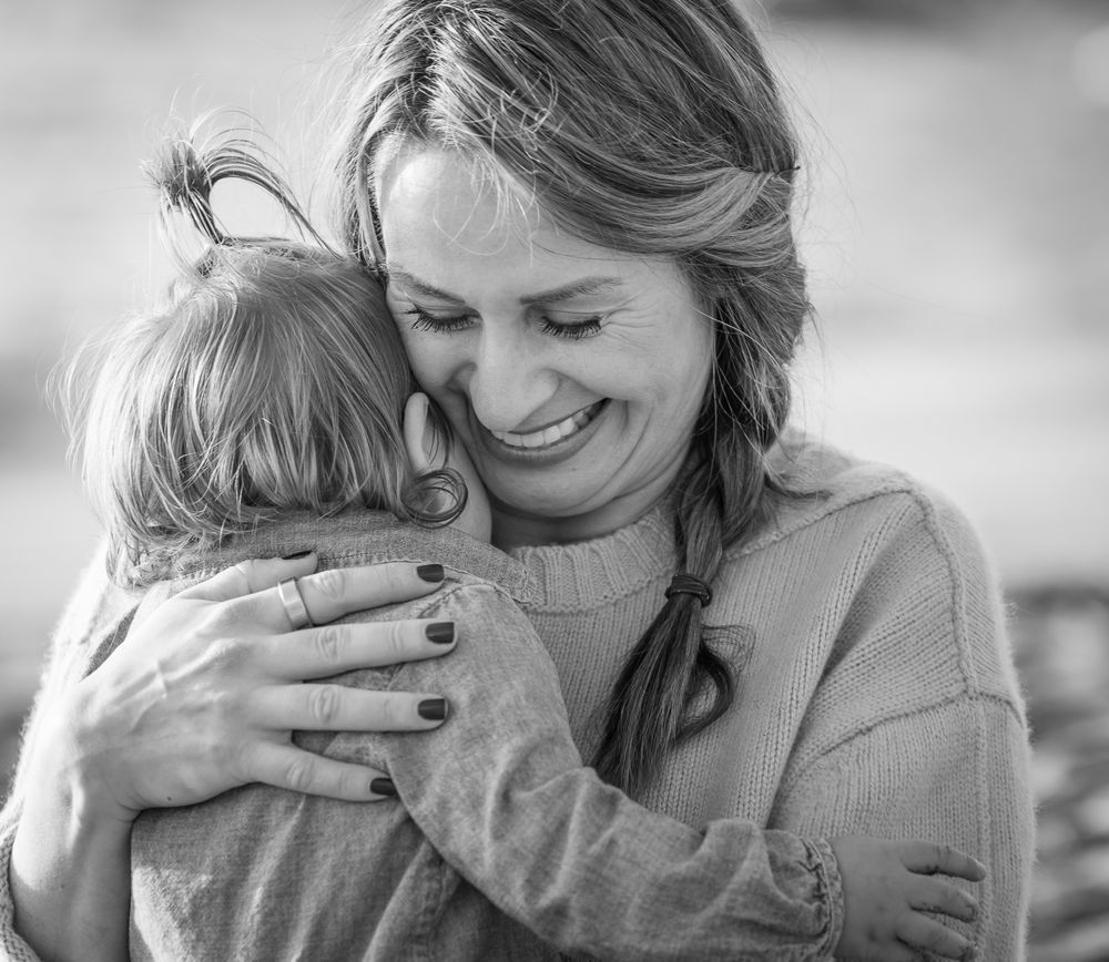 A tender moment of embrace captured in black and white showing affection and joy.