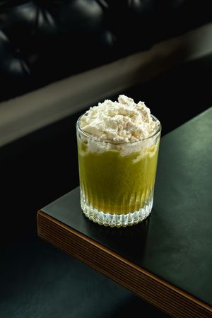 Single Chakra Colada cocktail with whipped coconut cream photographed at Radio Bar Spokane Cocktail Week