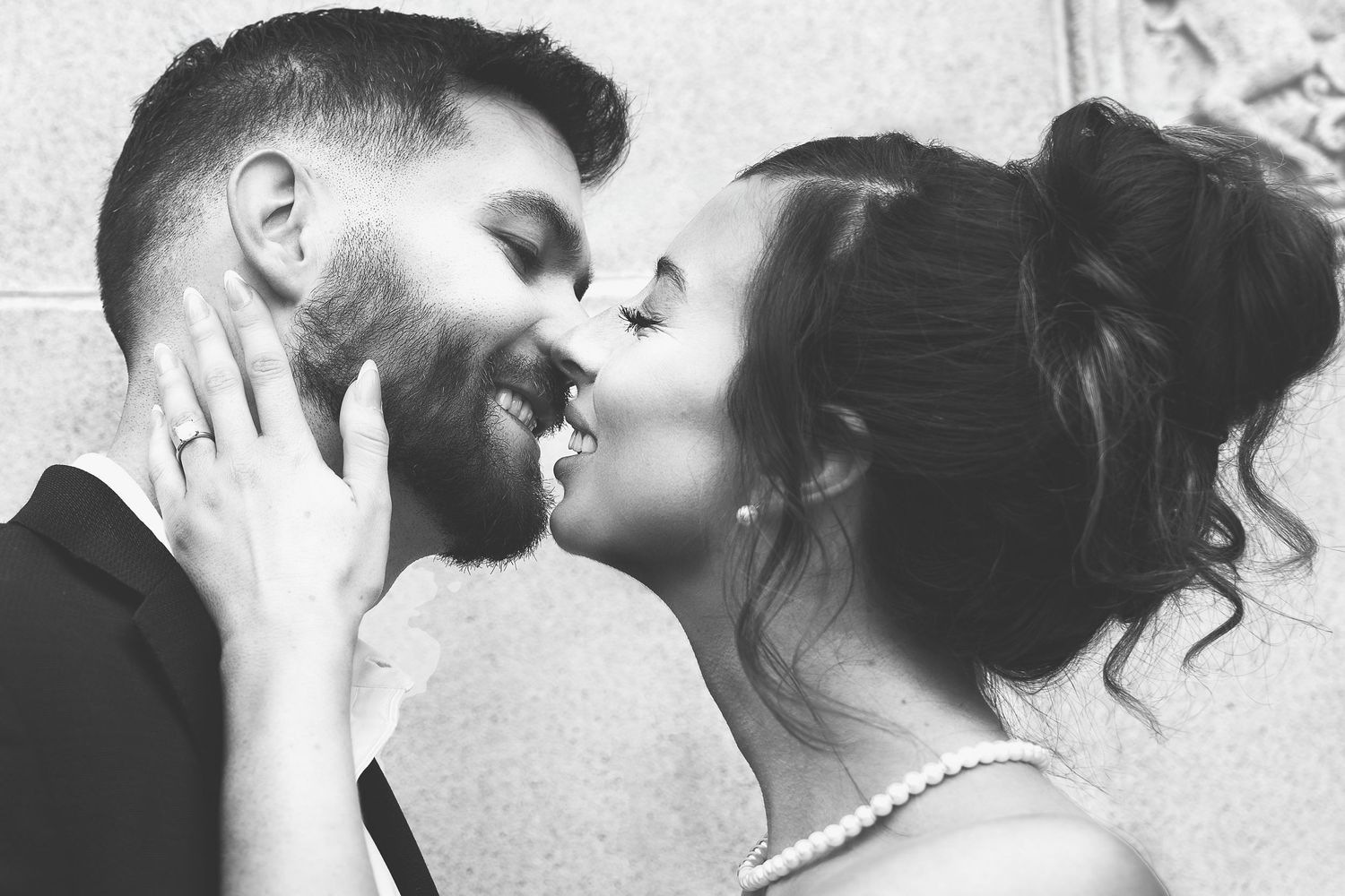 closeup black and white photo of a young man and woman about to kiss