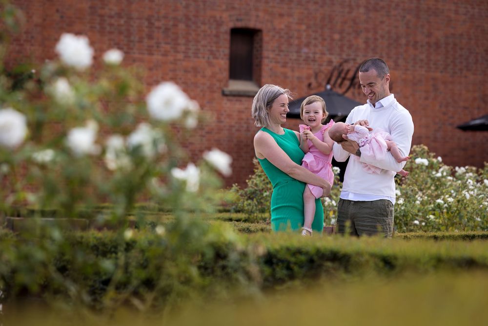 Family together in the rose garden in front of the castle at All Saints Estate in Wahgunyah.