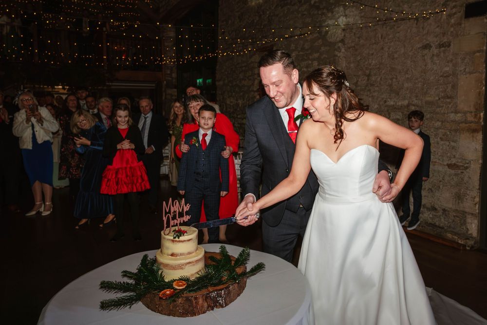 Priston Mill wedding photography Bath Somerset cake cut for bride and groom