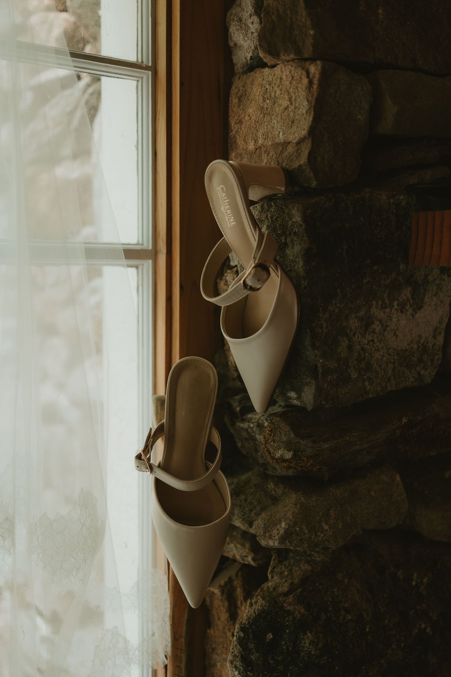A tender wedding couple embrace in golden sunlight during their outdoor celebration.