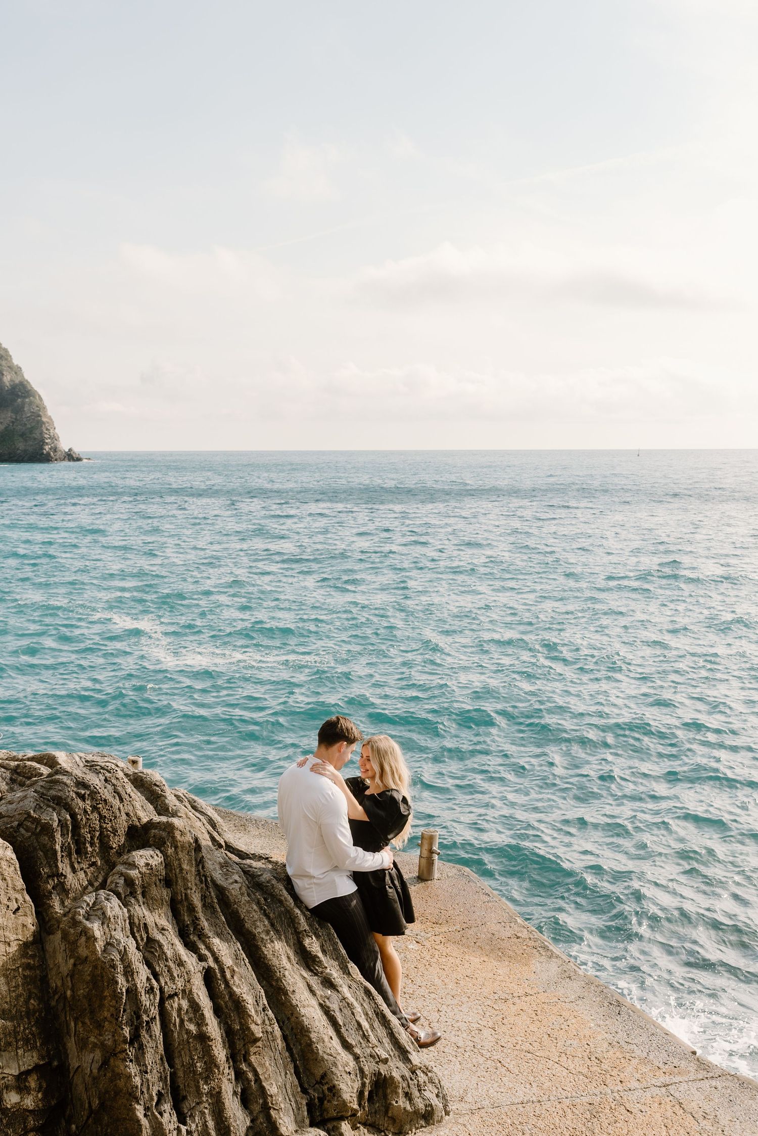 A joyful engagement photo capturing a loving moment with the picturesque Cinque Terre in the background