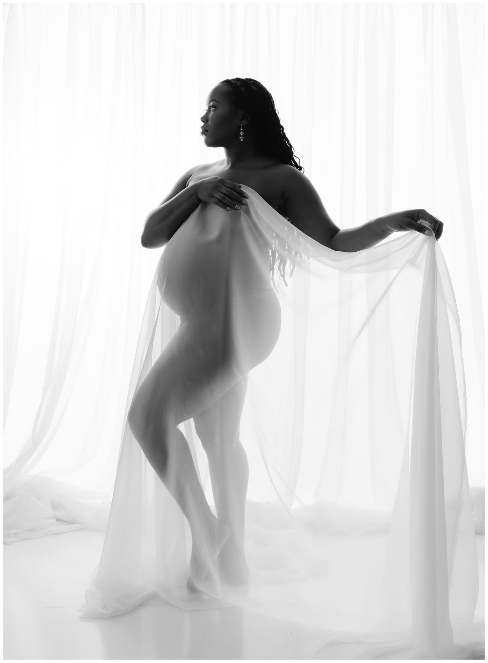 Fine art maternity silhouette portrait photographed in back light at Austin maternity photography studio