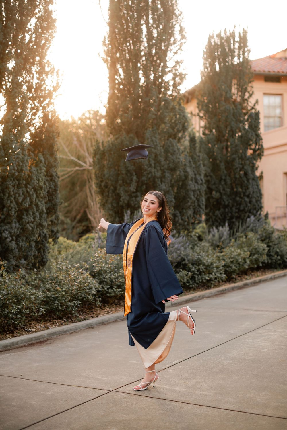 Pakistani muslim girl posing in a college graduation portrait taken at UC Davis Photographed by Shumesa Mohsin