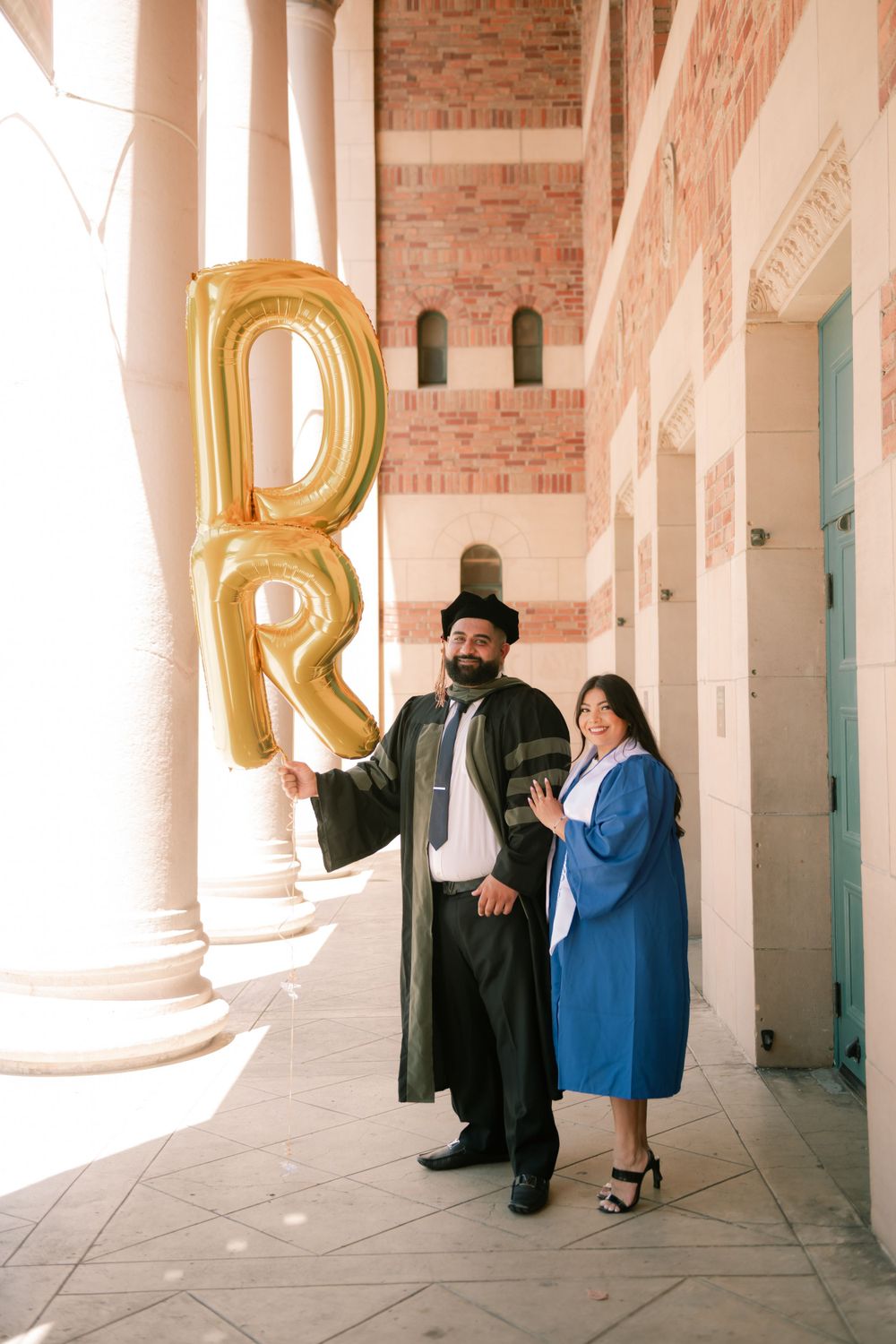 Two graduates pose in Sacramento California for their couple graduation shoot. Photographed by Shumesa Mohsin