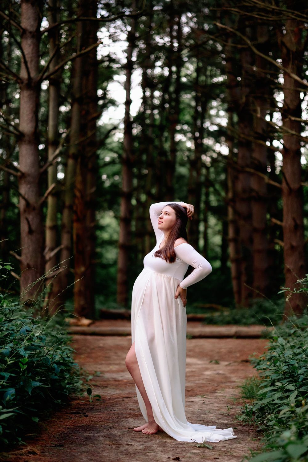 mom to be posed in woods for maternity photography