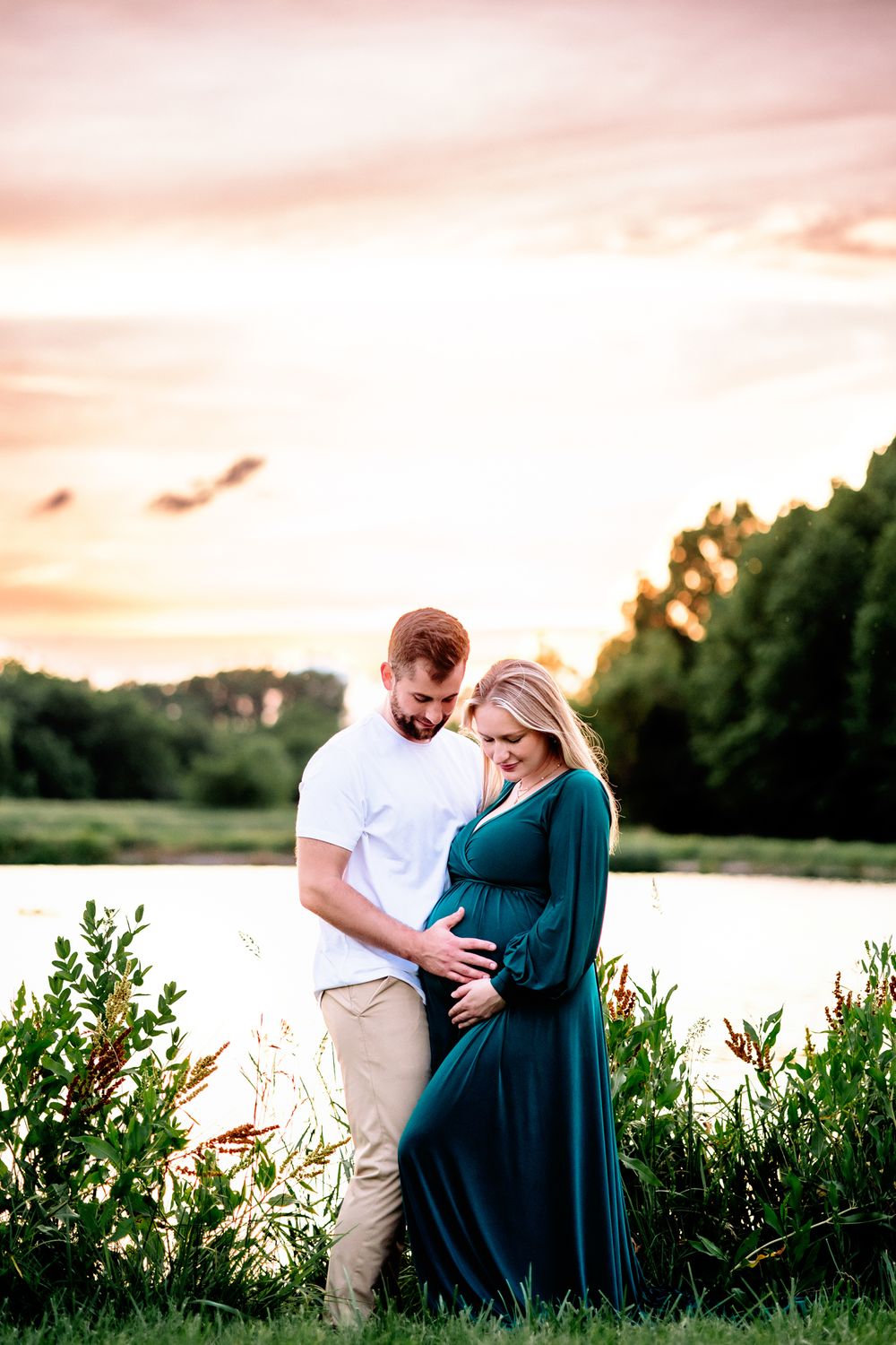 couple posed at sunset for maternity photoshoot