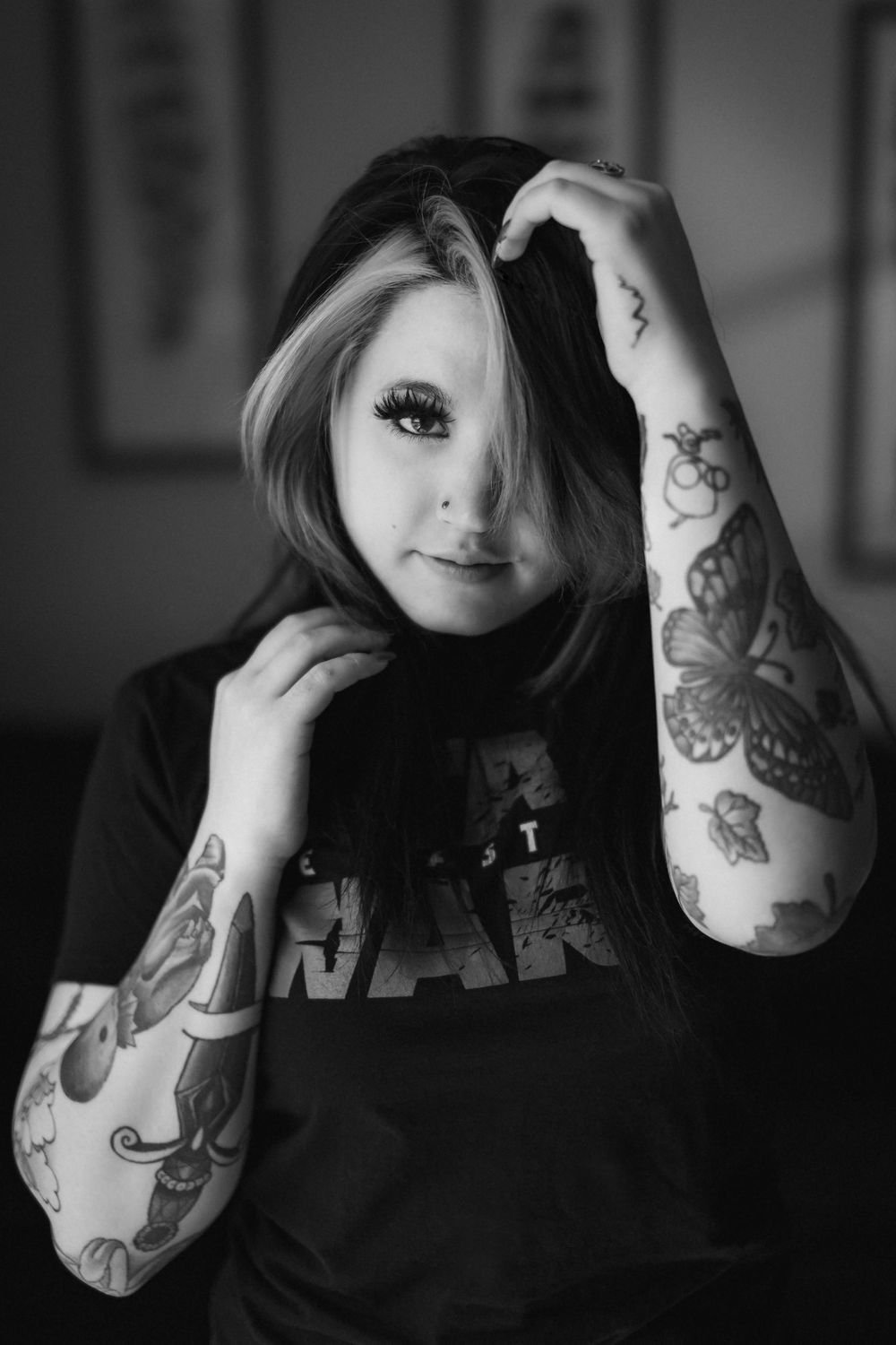 A black and white photo series showing tattooed arms and partial face against a dark background.