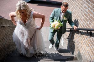 Wedding couple walking together on brick pavement during their special day.