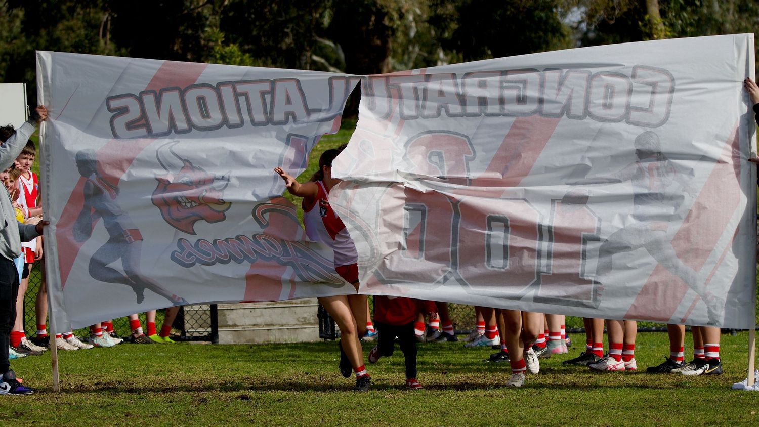 Junior footballer celebrating milestone match
