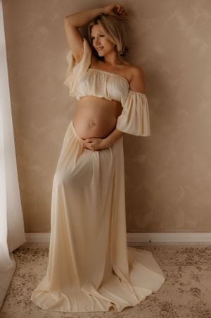 Modern maternity photoshoot showing graceful poses in a minimalist setting.