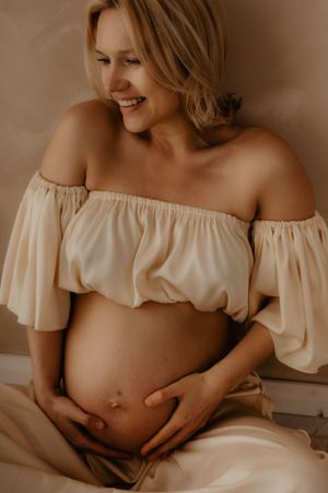 Dreamy maternity photography sequence with soft lighting and ethereal white fabric.