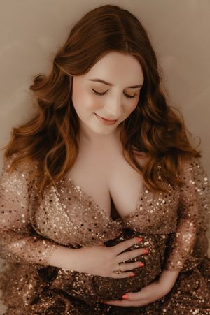 Artistic maternity photo series featuring a sparkly sheer dress in warm sepia tones.
