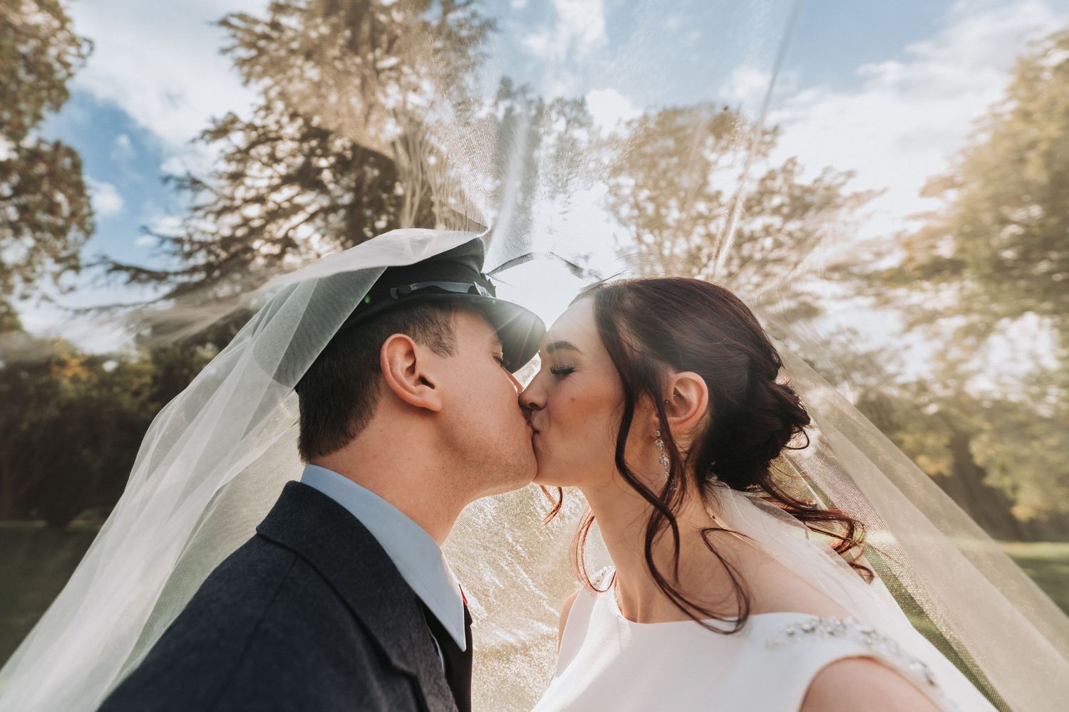 Couple kiss on the beach for their engagement