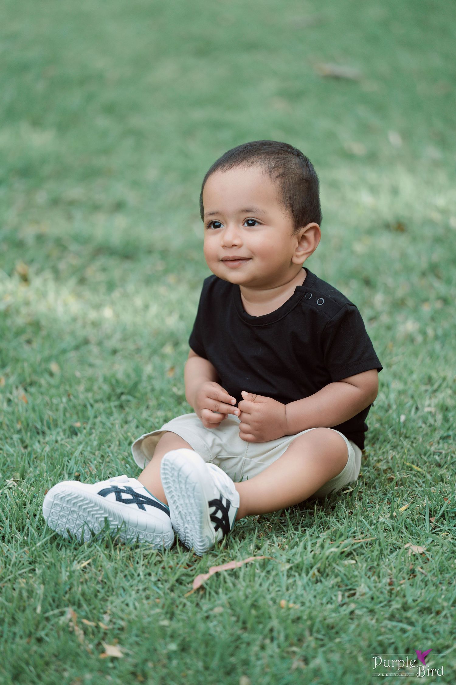 Smiling toddler sitting on green grass on a sunny day - natural kids photography, Wollongong family photoshoot