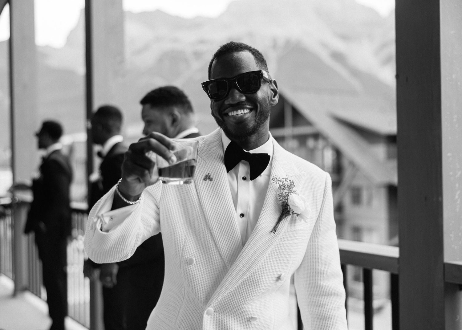 Groom in sunglasses and a white tuxedo jacket with groomsmen, Canmore wedding