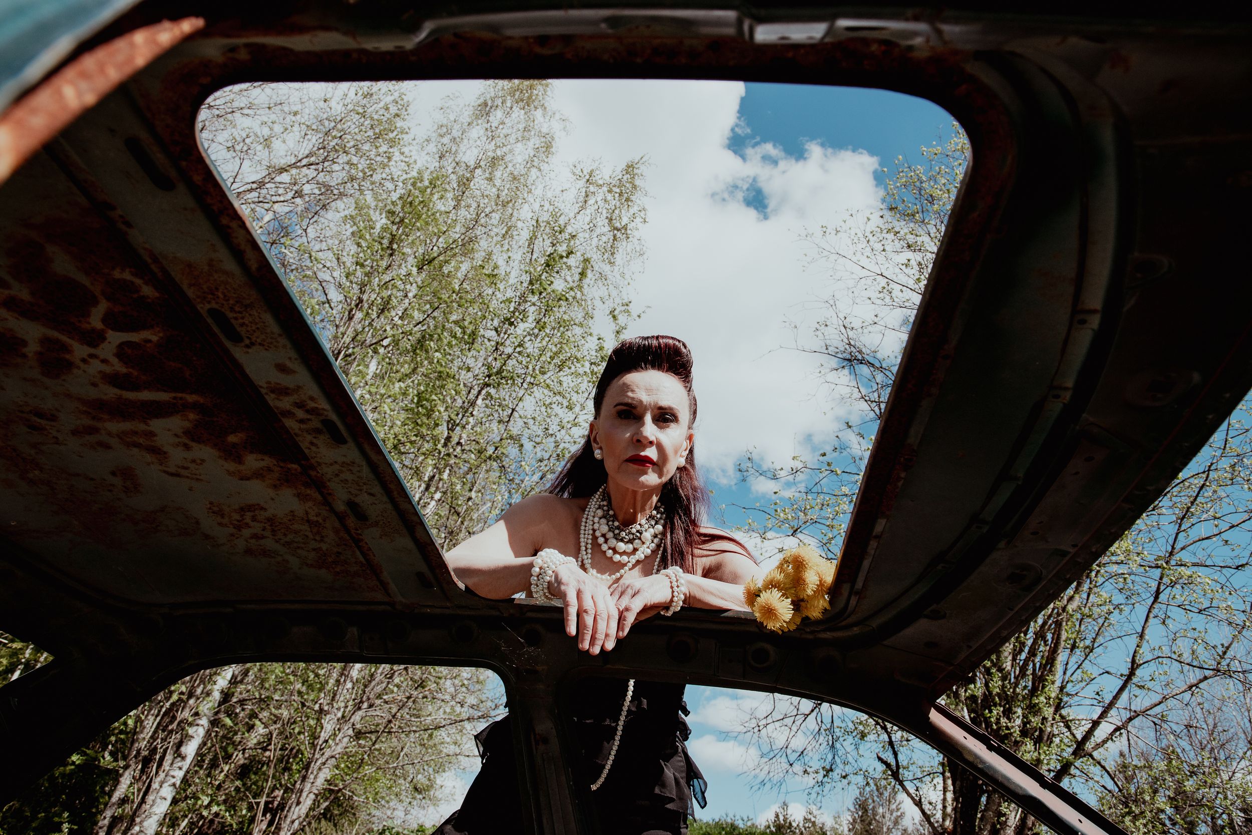 Woman looking through the car roof