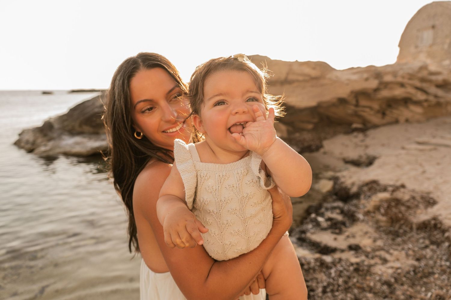 A mum and a baby daughter enjoying their time on the beach in Mallorca in Colonia de Sant Jordie.