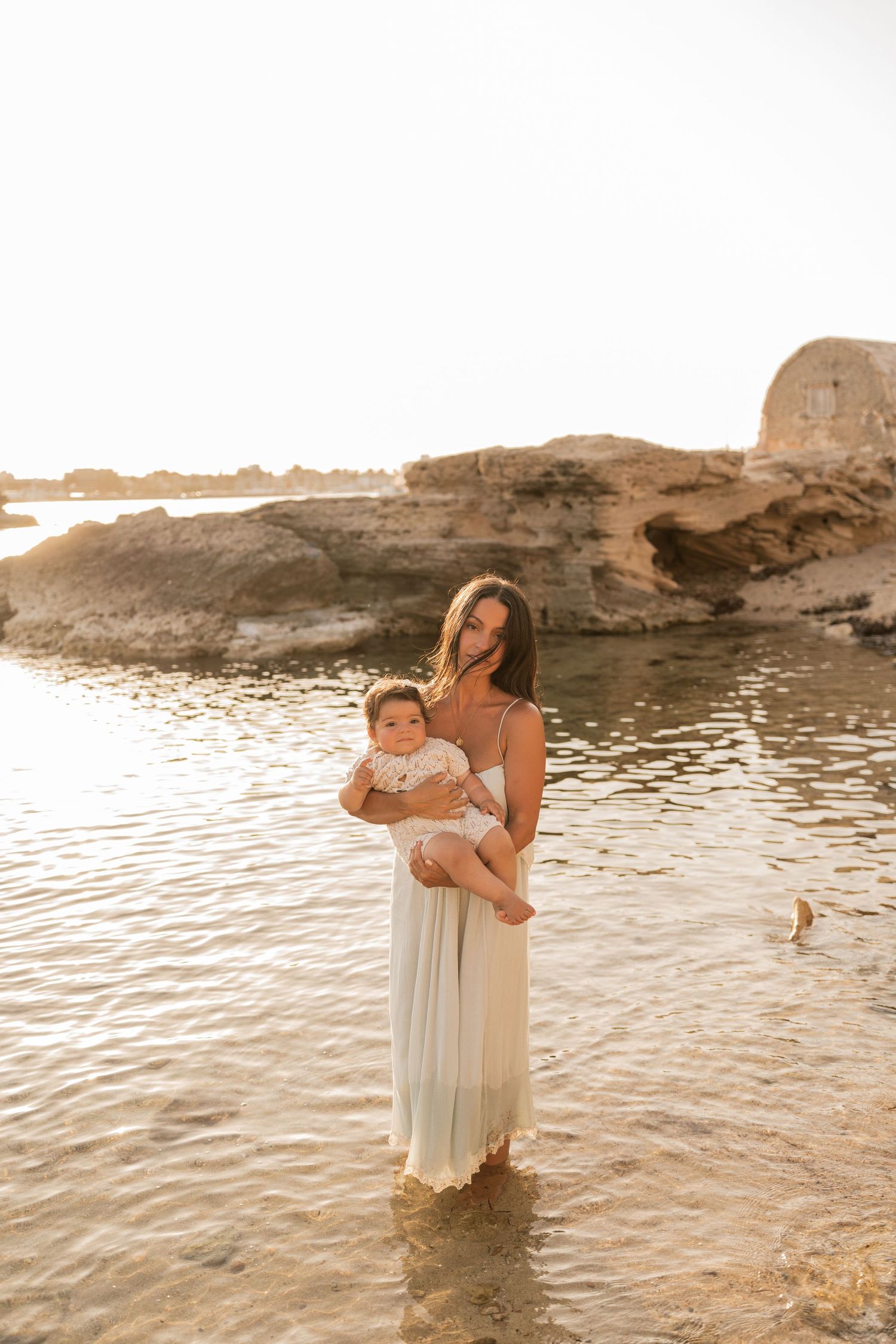 A mum and her baby enjoying their time on the beach in Mallorca in Colonia de Sant Jordie.