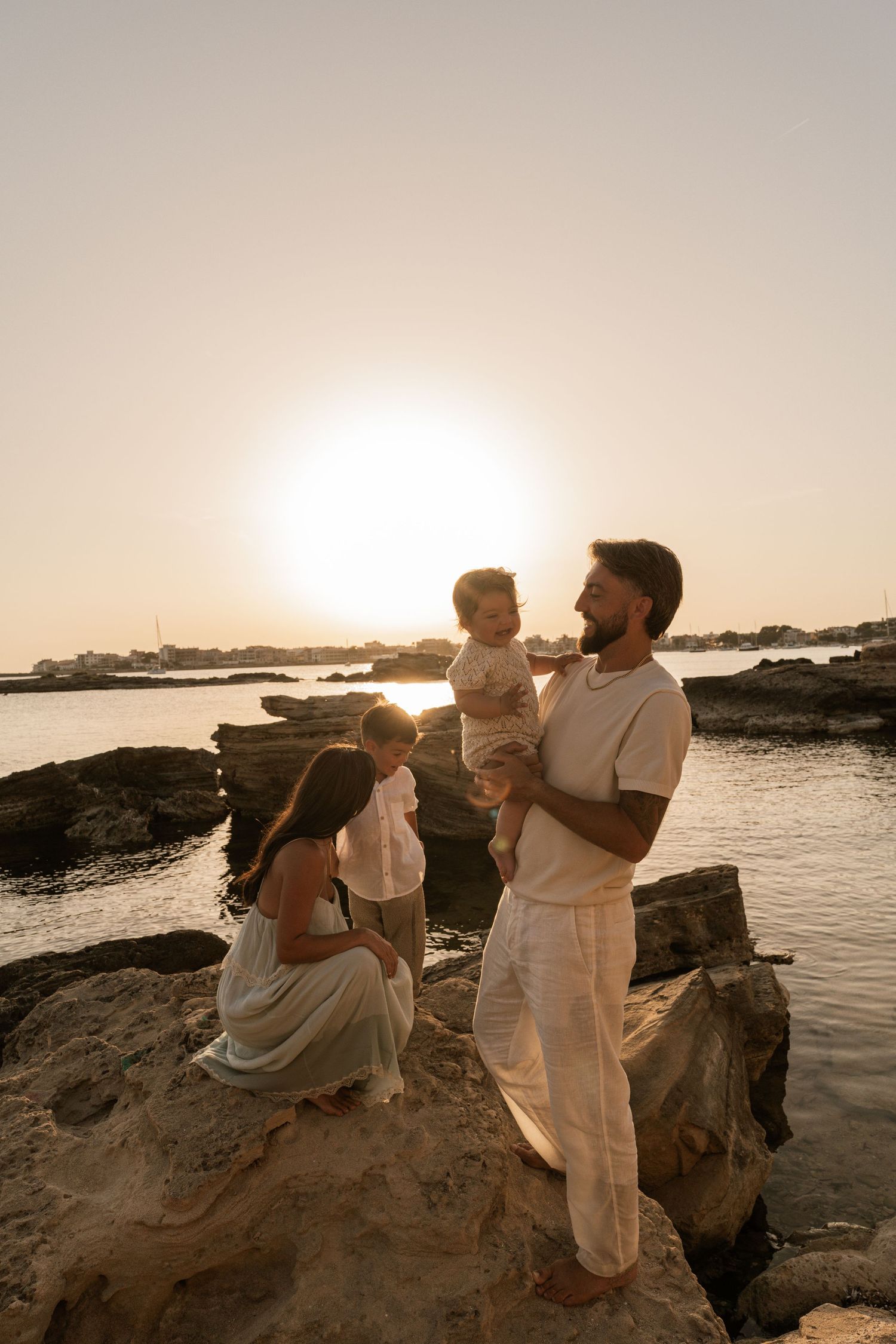 A family enjoying their time on the beach in Mallorca in Colonia de Sant Jordie at sunset.